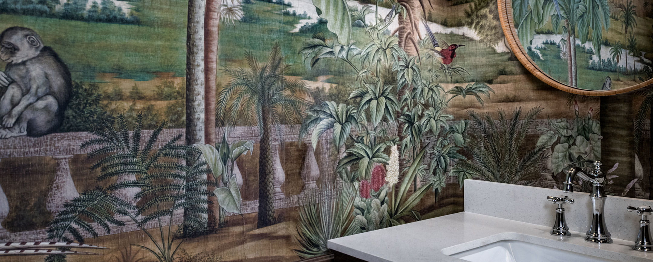 Detail of a cozy bathroom with forest-themed wallpaper