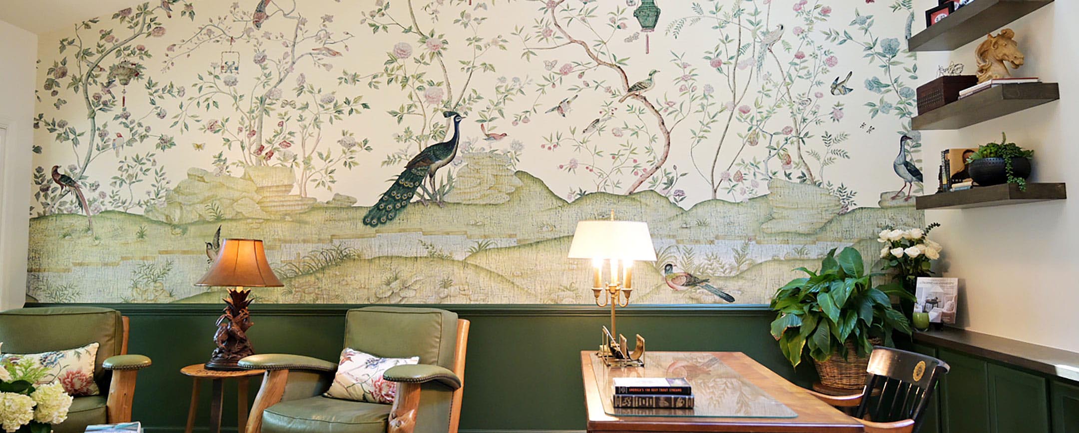 Detail of a cozy bedroom scene with floral wallpaper and matching bedspread